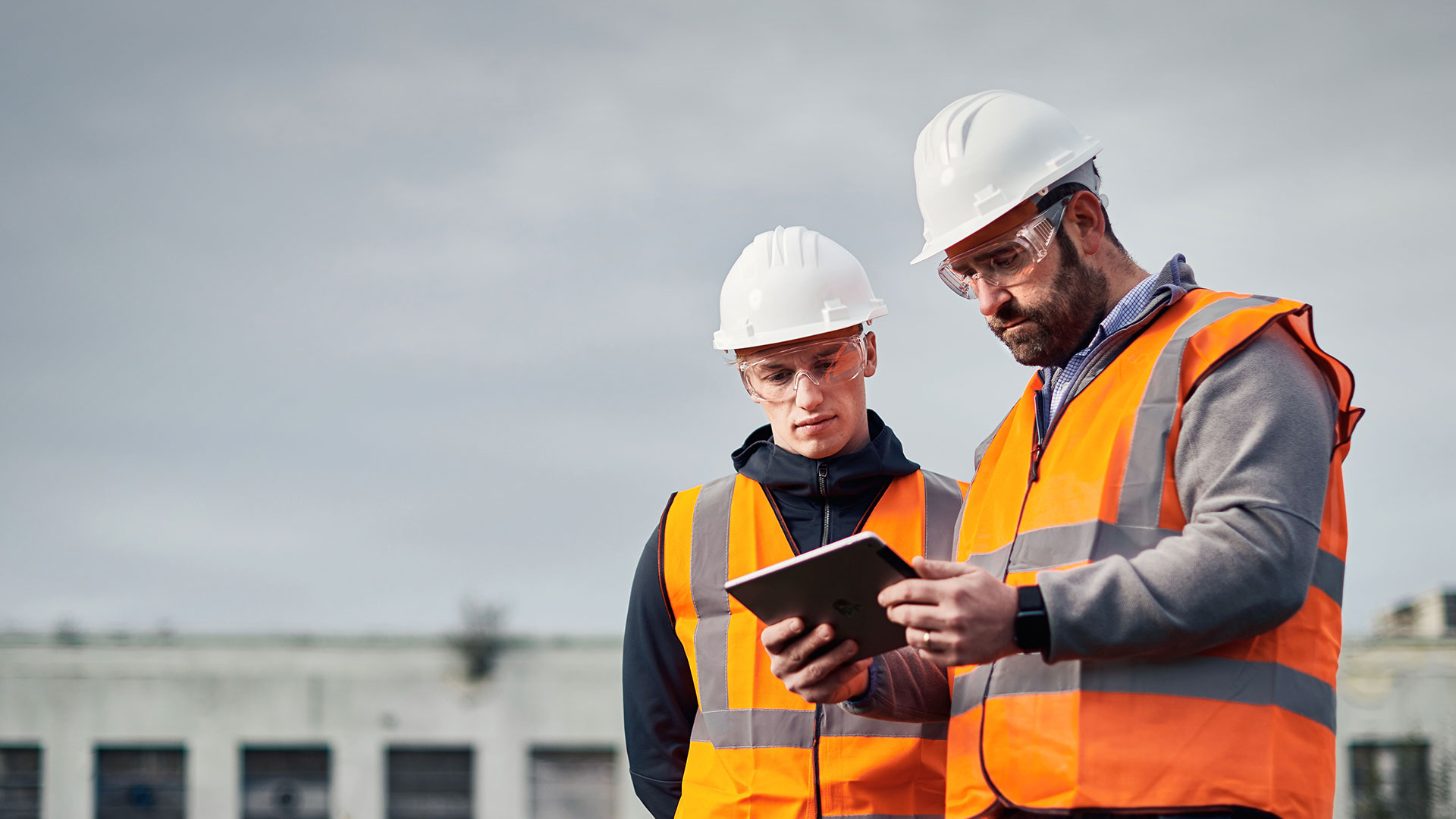 2-male-workers-looking-at-ipad